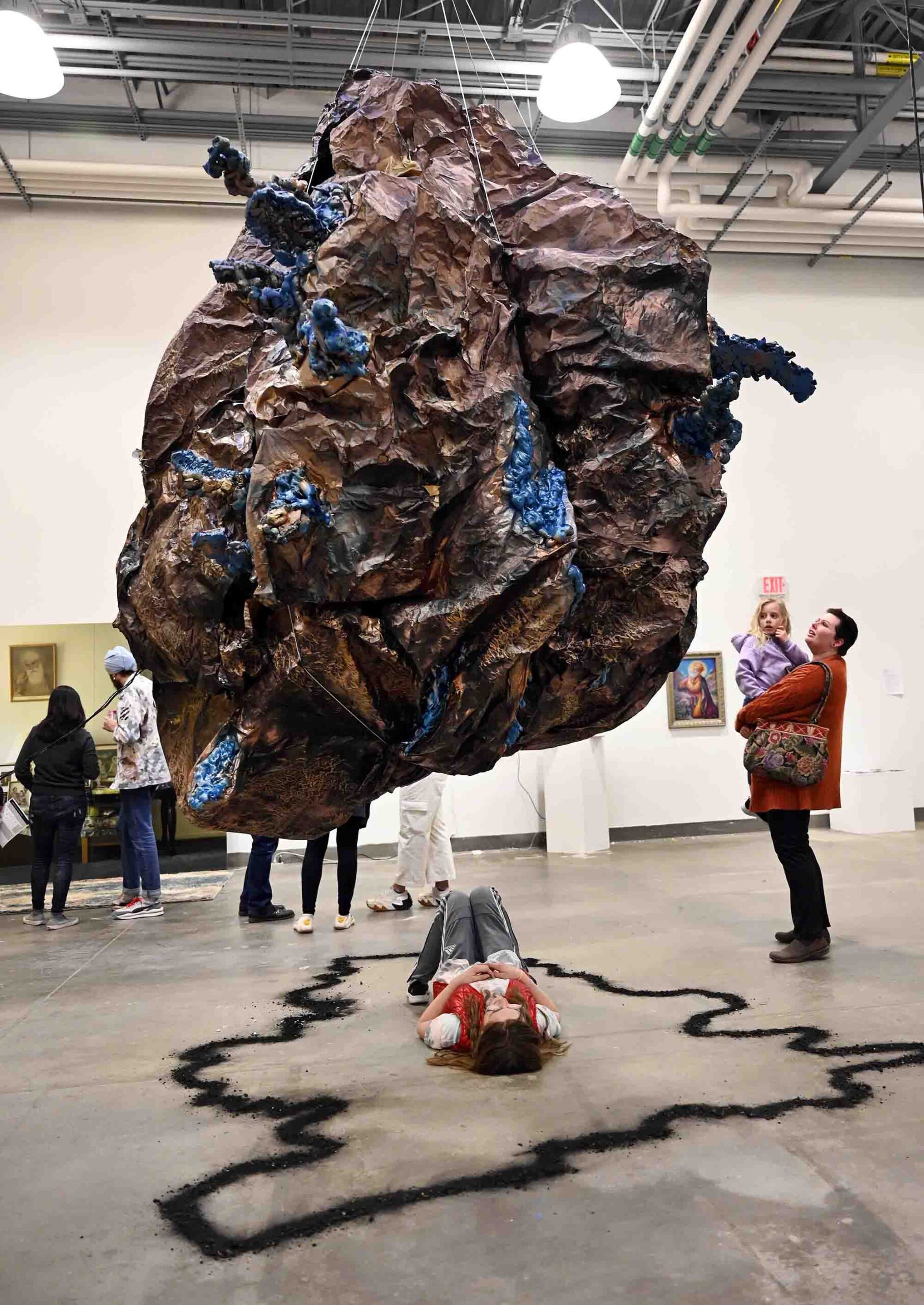 breathing boulder sculpture with spectators